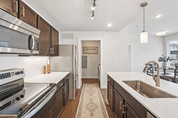 Galley kitchen with stainless appliances and island sink